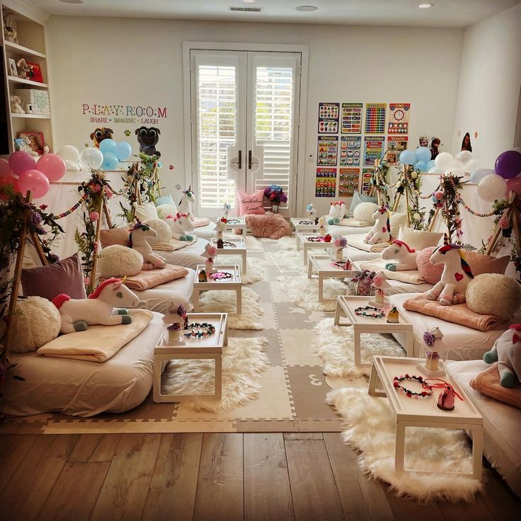 a room filled with lots of white furniture and balloons on the wall behind it,