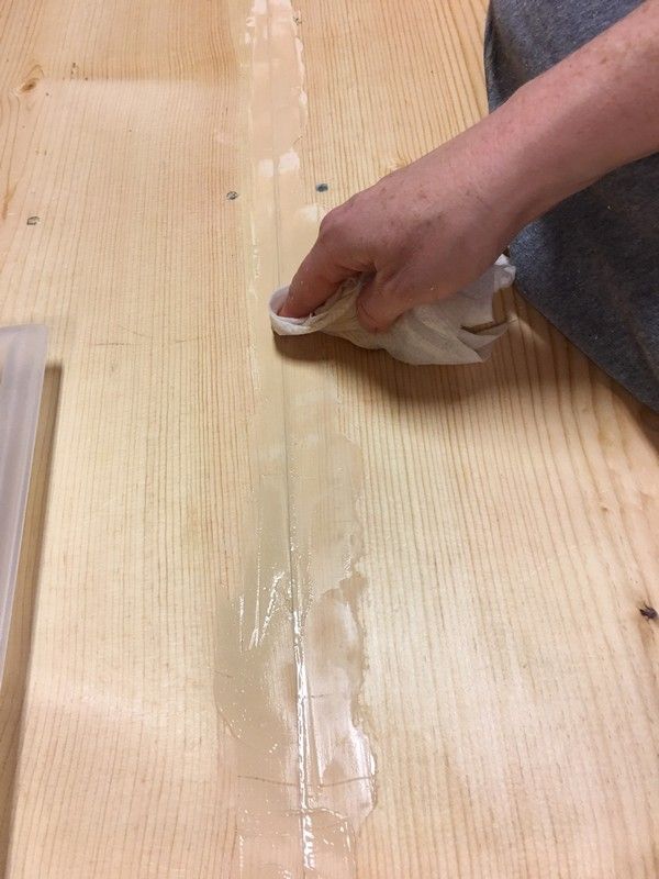 a person is sanding wood on top of a table