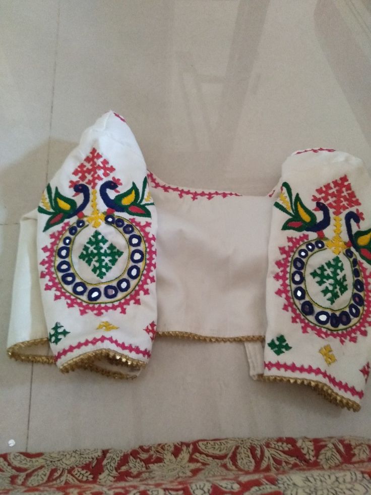 two pieces of cloth with embroidered designs on them