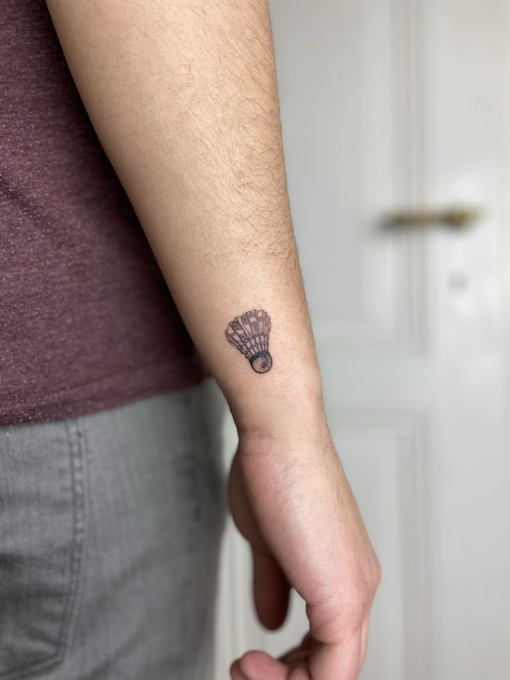 a person with a small tattoo on their arm