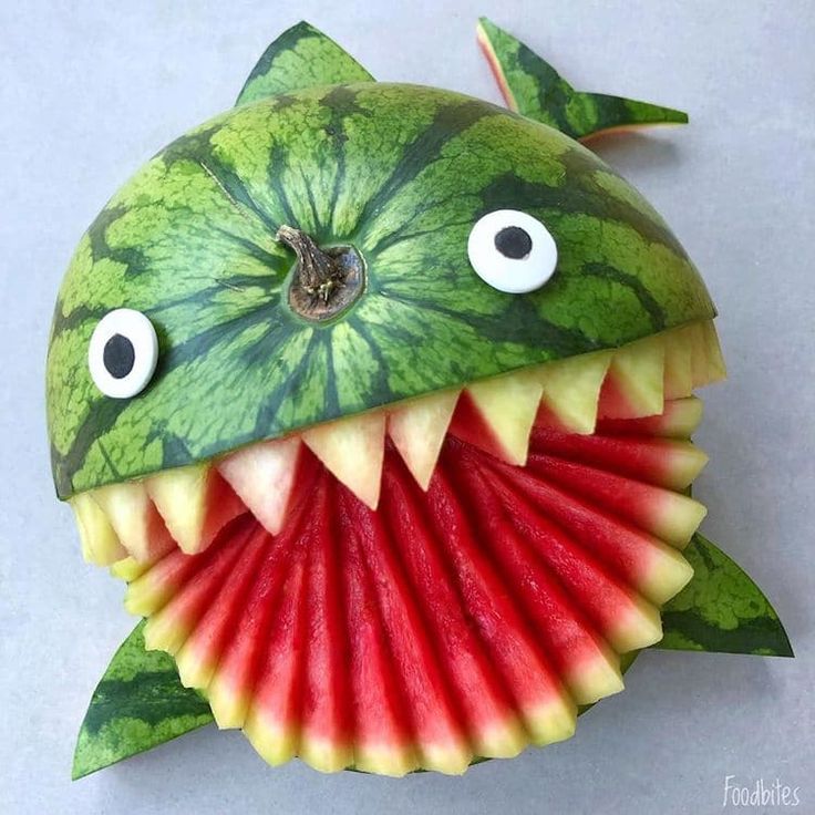 a watermelon shaped like a fish with its mouth open and eyes wide open