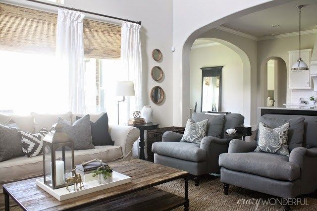 a living room filled with furniture and windows