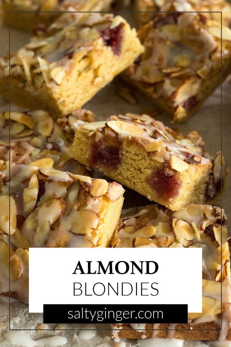 Sliced almond blondies on baking parchment.