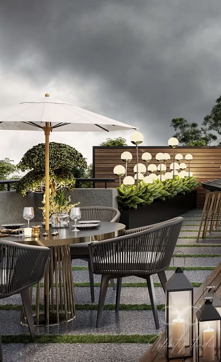 an outdoor dining area with tables and umbrellas on the roof terrace, surrounded by greenery