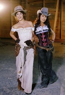 two women dressed in western clothing standing next to each other