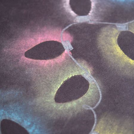 a close up view of some black and white circles on a table cloth with colored lights