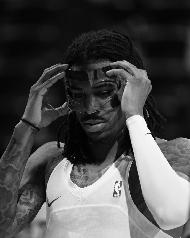 a man with dreadlocks holding his head