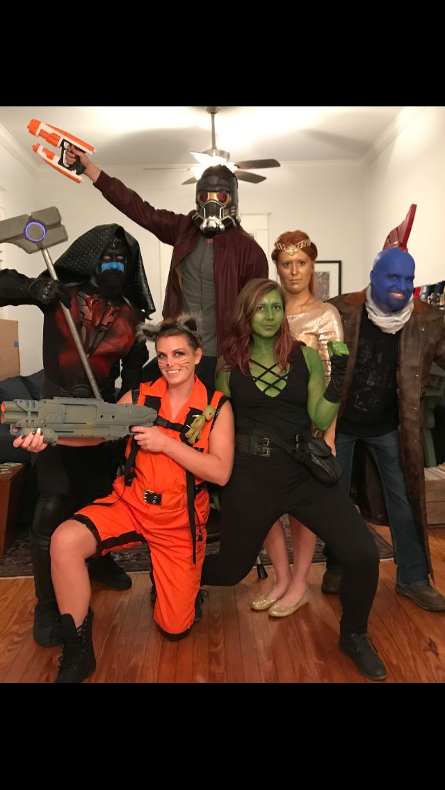 a group of people in costumes posing for a photo