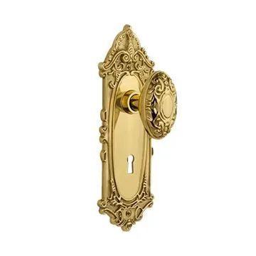 an ornate brass door handle on a white background