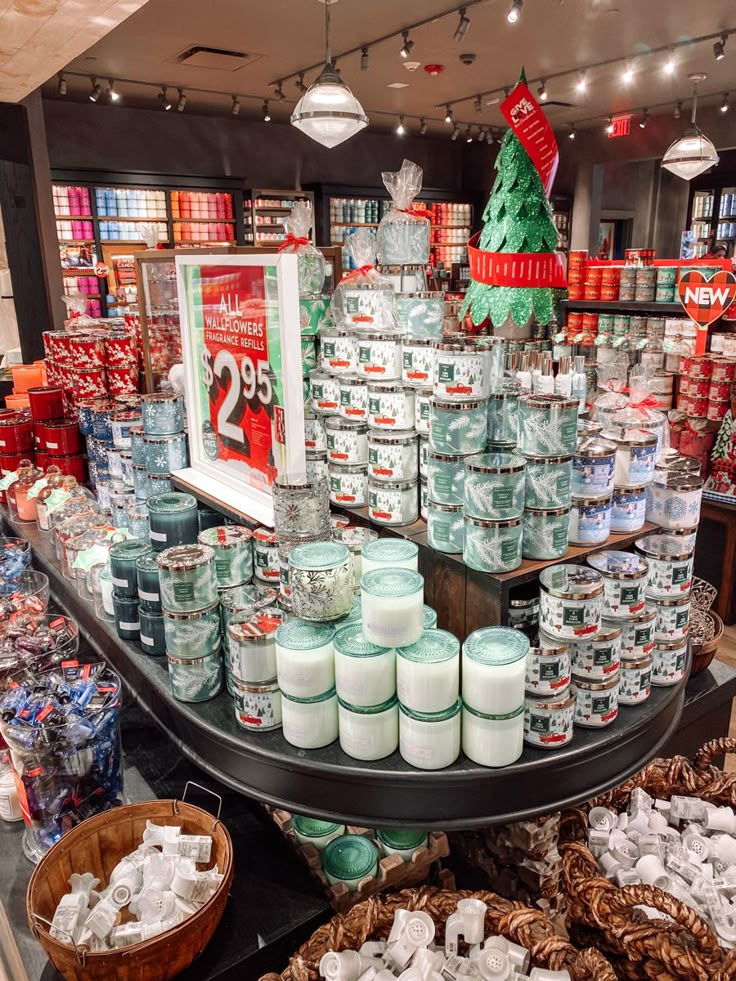 a display in a store filled with lots of candles and christmas decorations on top of it