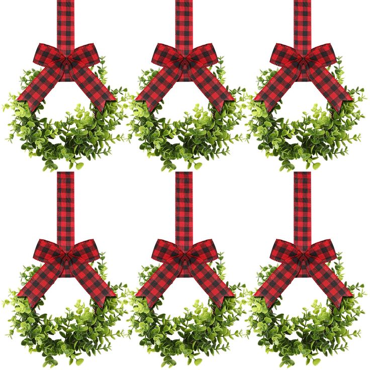 a set of four christmas wreaths with red and black plaid bows