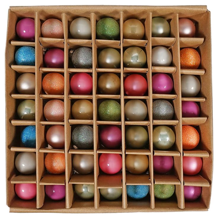 a wooden box filled with lots of different colored balls on top of eachother