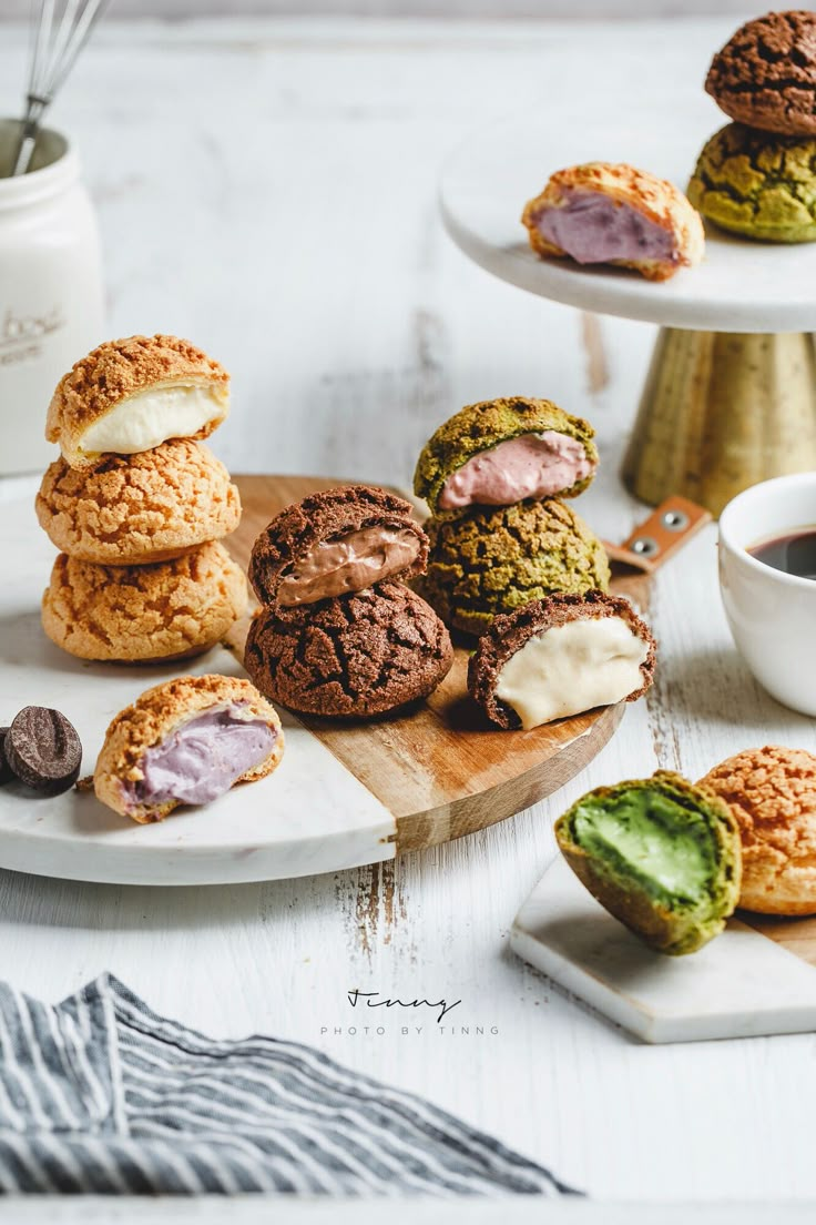 several cookies and pastries on plates next to a cup of coffee