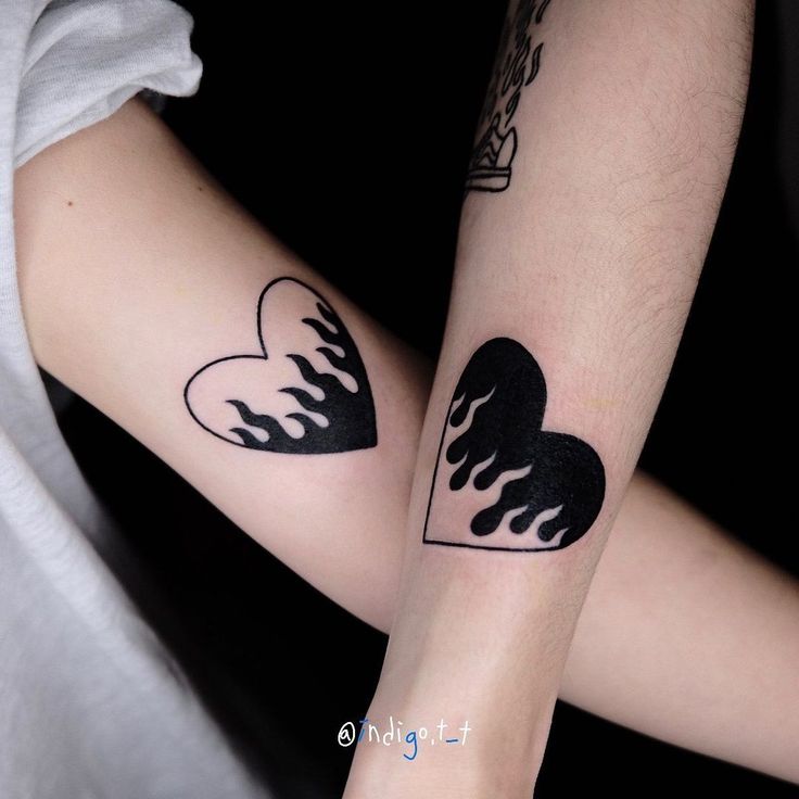 two people with matching tattoos on their arms