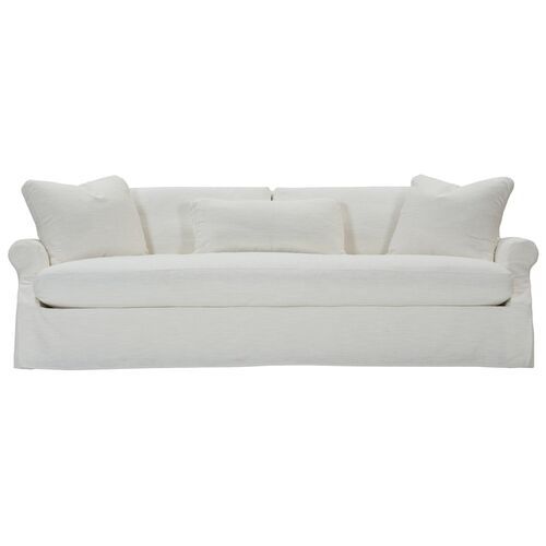 a white couch with four pillows on it