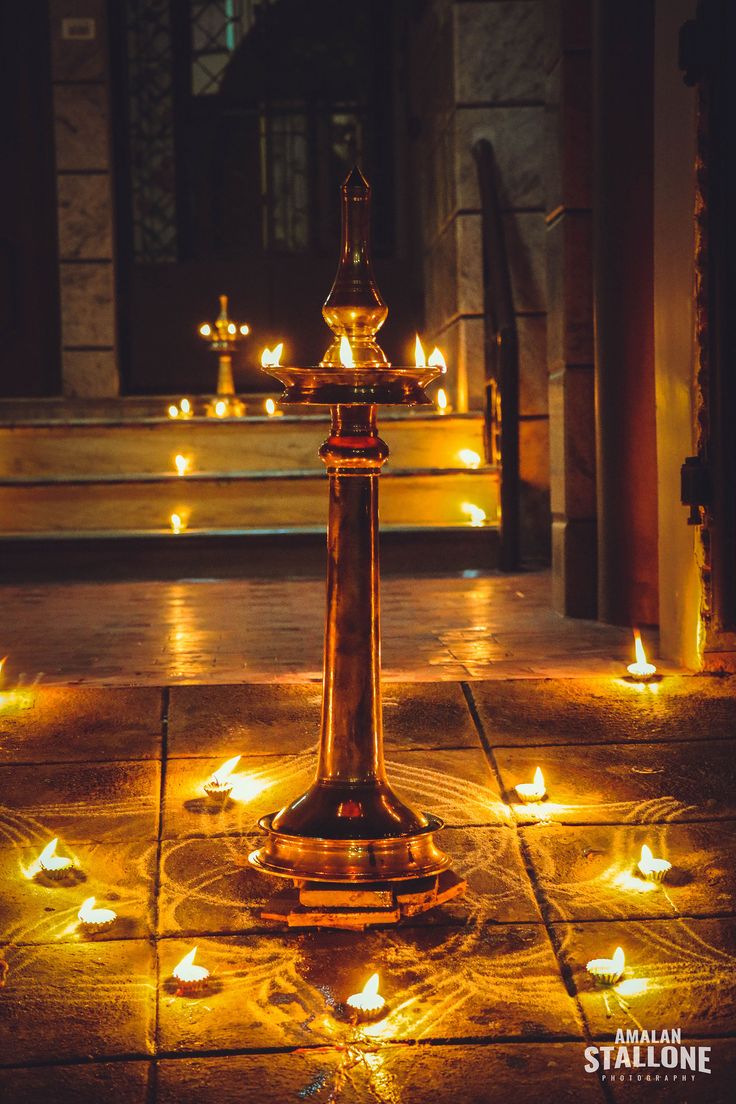 candles are lit on the ground in front of a church