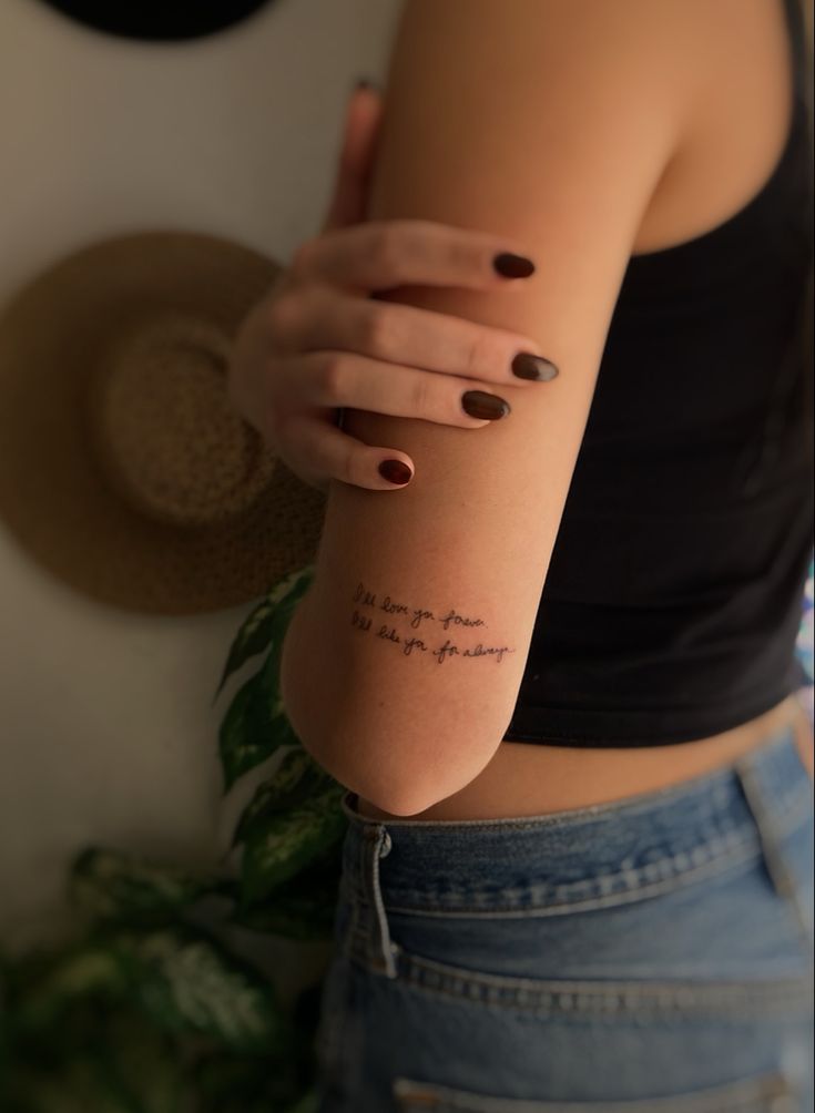 a woman with a tattoo on her arm