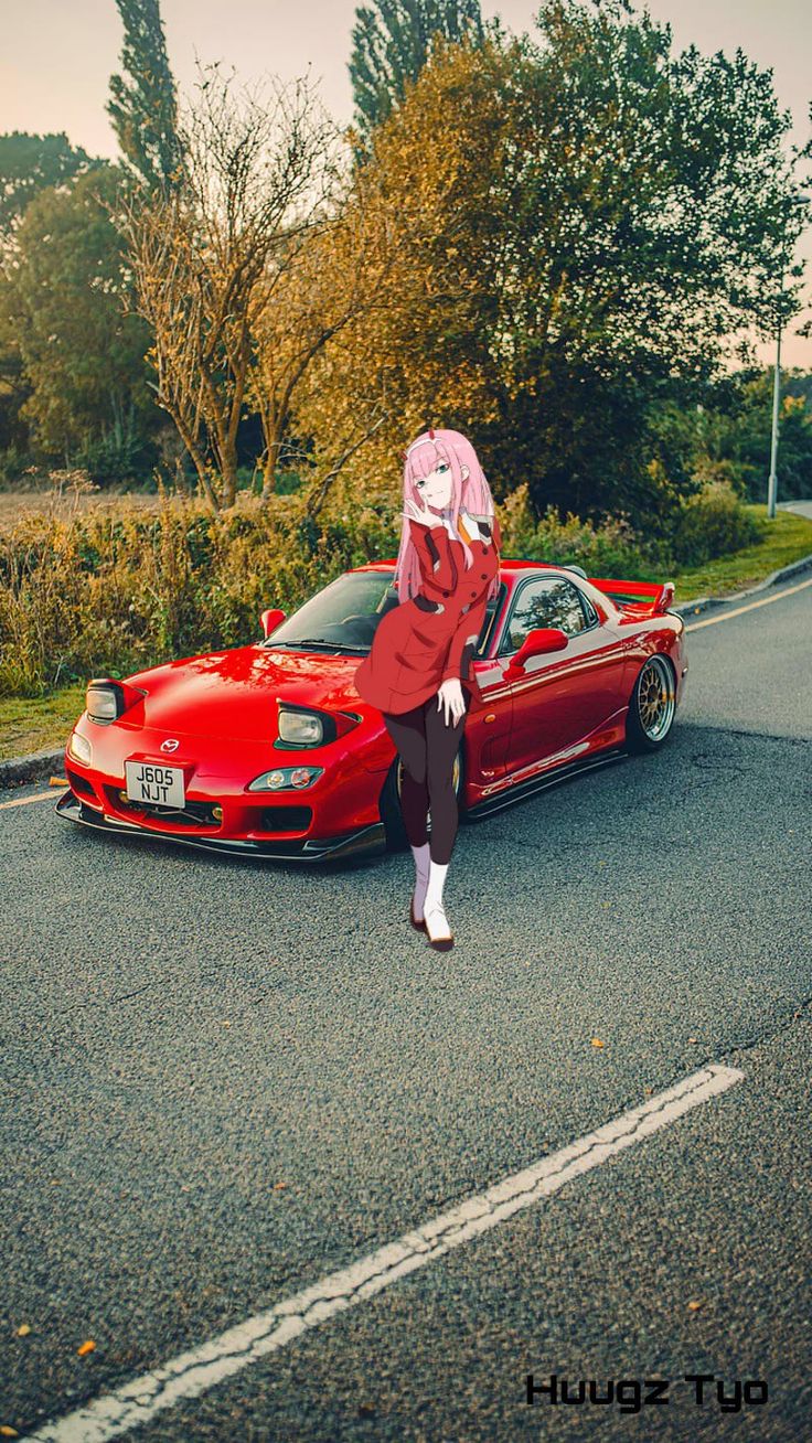 a woman sitting on the hood of a red sports car