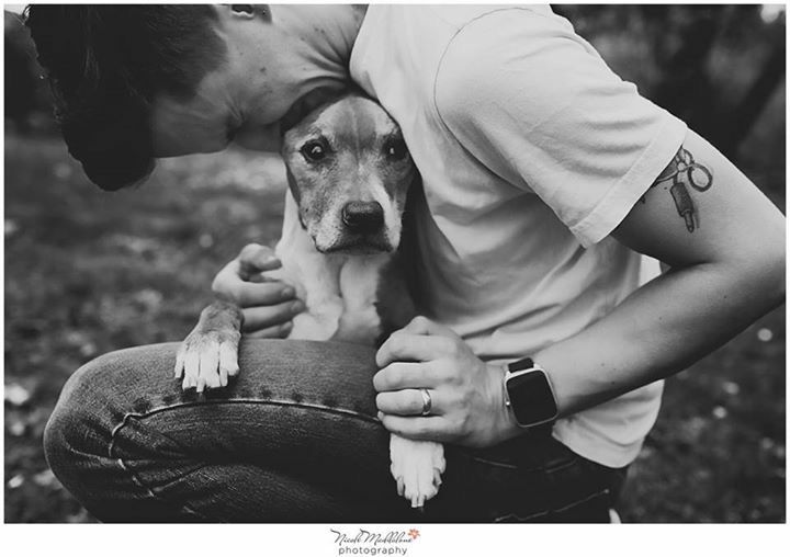 a man holding a small dog in his lap