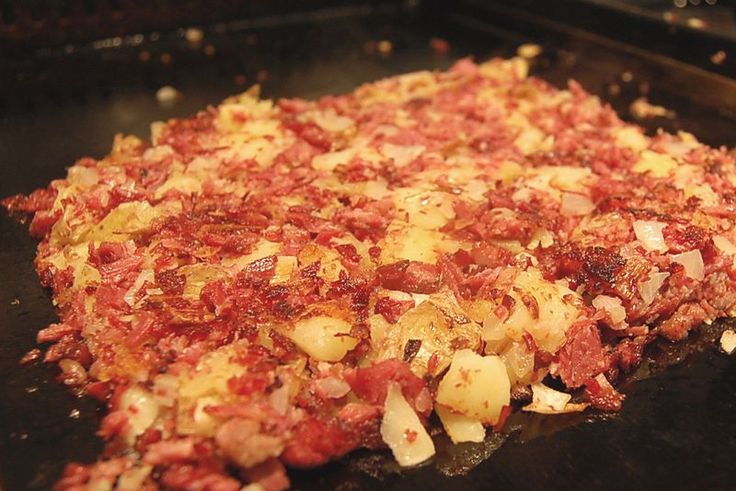 an uncooked pizza sitting on top of a pan in the oven with toppings