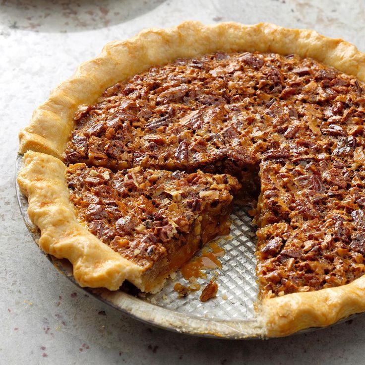 a pecan pie with one slice missing from it