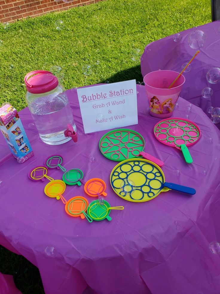 a purple table topped with lots of different items