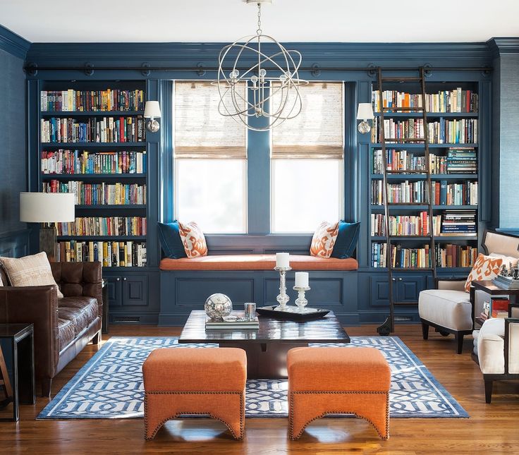 a living room filled with lots of furniture and bookshelves full of books on shelves