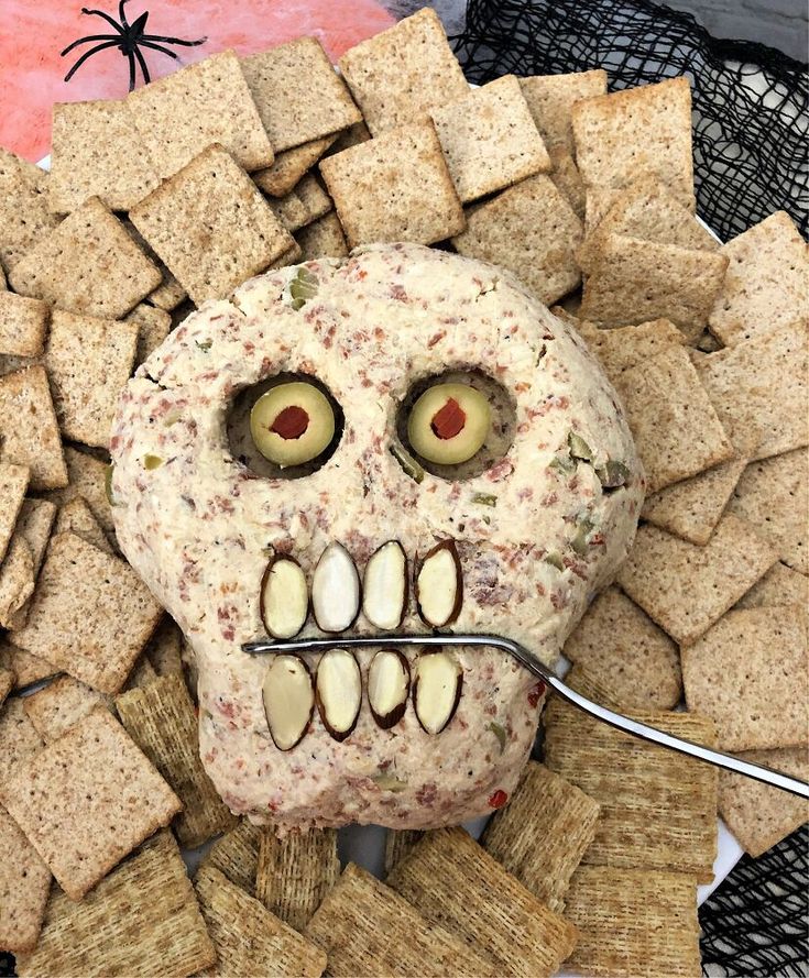 a skull made out of crackers and cheese with eyes on it's face