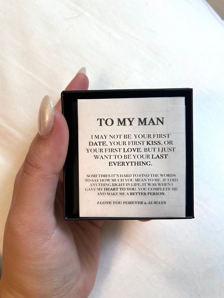 a person holding up a card with the text to my man