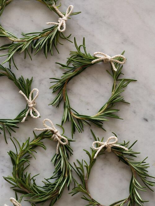 several small wreaths tied with twine on top of a marble countertop next to an instagram post