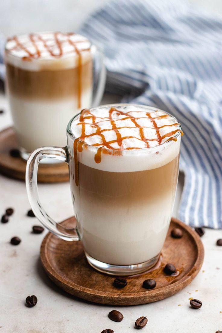 two glasses of coffee with caramel drizzled on top