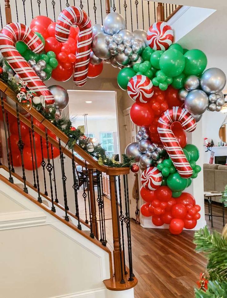 a staircase decorated with christmas balloons and candy canes