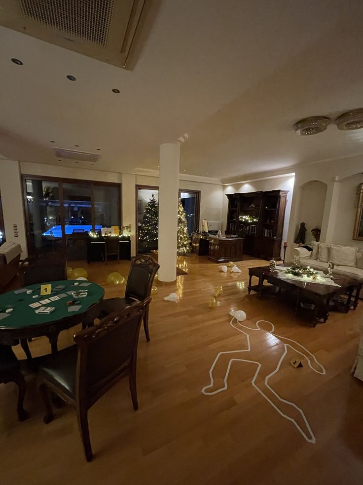 a living room filled with lots of furniture and christmas decorations on the floor in front of large windows