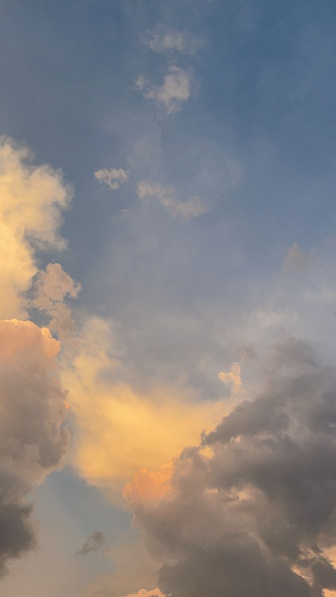 the airplane is flying high in the sky with clouds behind it and one plane on the ground