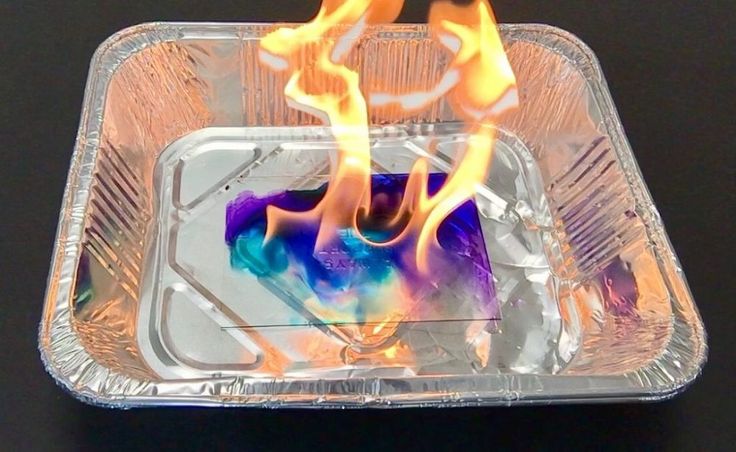 a plastic container filled with flames on top of a table