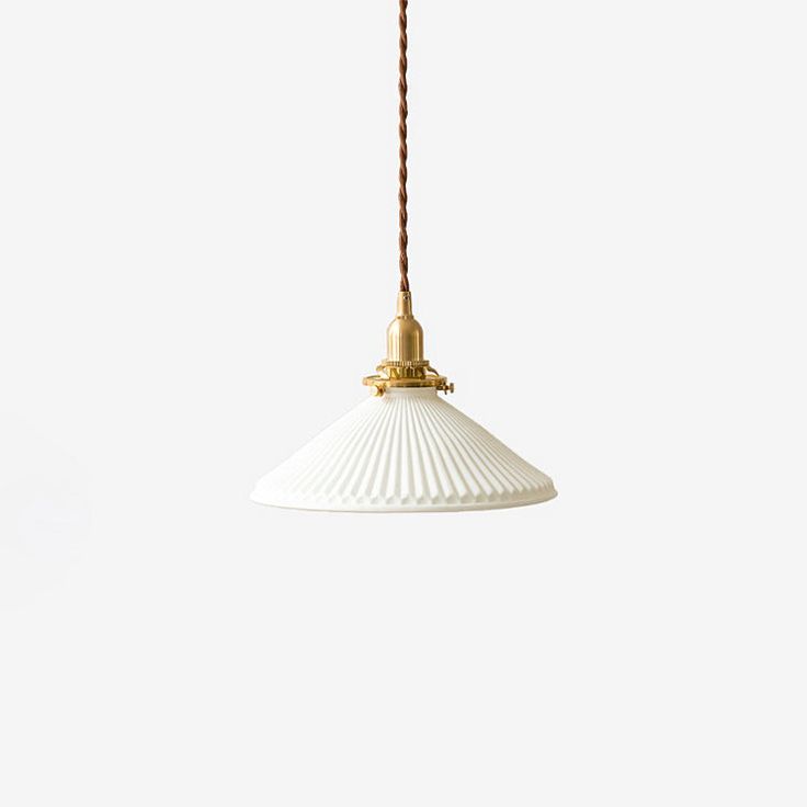 a white and gold pendant light hanging from a cord