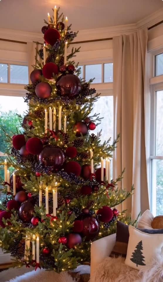 a christmas tree decorated with candles and ornaments