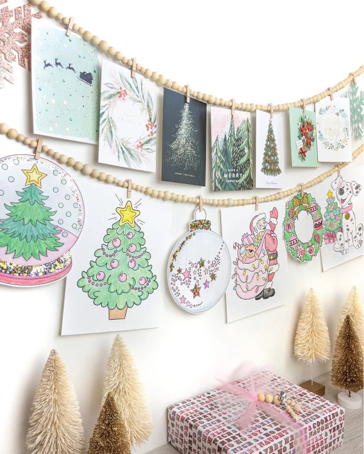 there are many cards hanging on the wall next to christmas trees and presents in boxes