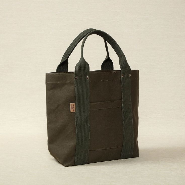 Heavy weight canvas medium tote in khaki green 16.5" x 5.5" x 12.6" Made in Japan Threadline is a Japanese-manufactured line of heavy canvas bags designed for everyday use. Khaki Canvas Tote Bag For Daily Use, Khaki Tote Canvas Bag For Daily Use, Green Canvas Bag For Everyday Use, Khaki Tote Canvas Bag For Everyday Use, Practical Green Canvas Bag For Daily Use, Khaki Canvas Tote Bag For Everyday, Practical Green Canvas Bag For Everyday, Everyday Khaki Canvas Tote Bag, Khaki Canvas Bag With Top Carry Handle