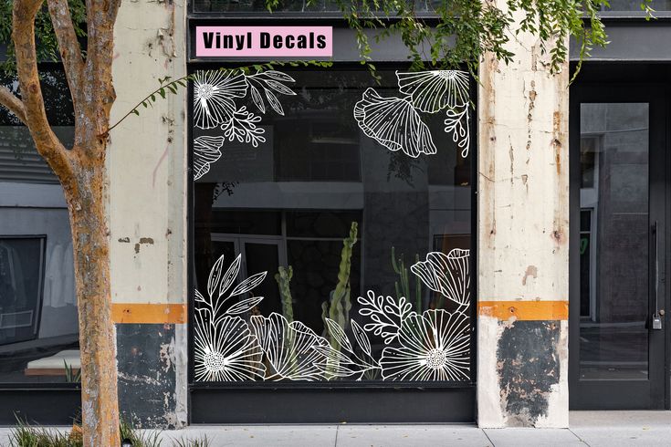 a store front with an etched glass window and cactus in the doorway, on a city street