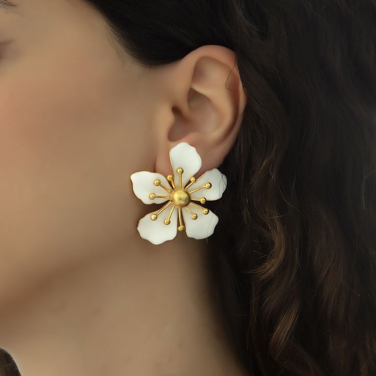 The magnolia flower meaning is attached with the symbols of nobility, perseverance, and love of nature. Soft and subtle in color yet strong in appearance, the flower is representative of the beauty encompassing femininity and gentleness. These earrings are handmade with 22K gold plated brass and enamel. These nickel free earrings are for pierced ears. They come as a pair with both butterfly and silicone earring backs. These beautiful earrings come with the Milou Jewelry box For avoiding damage t Elegant Birth Flower Earrings, Elegant Petal-shaped Blossom Jewelry, Elegant Blossom-colored Spring Jewelry, Elegant Spring Blossom Colored Jewelry, Elegant Spring Petal Shaped Flower Earrings, Spring White Birth Flower Jewelry, Classic Flower Earrings For Formal Occasions, Elegant Blossom Earrings For Gift, Elegant Blossom Color Flower Earrings For Gift