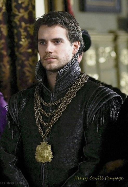 a man dressed in medieval clothing with chains around his neck