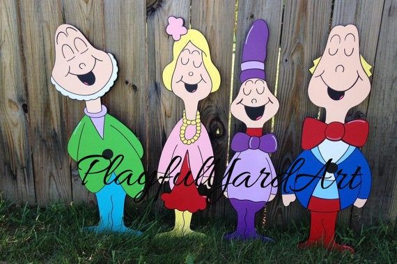 three cartoon characters standing next to each other in front of a wooden fence with grass