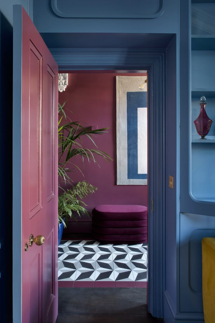 an open door leading to a room with pink walls