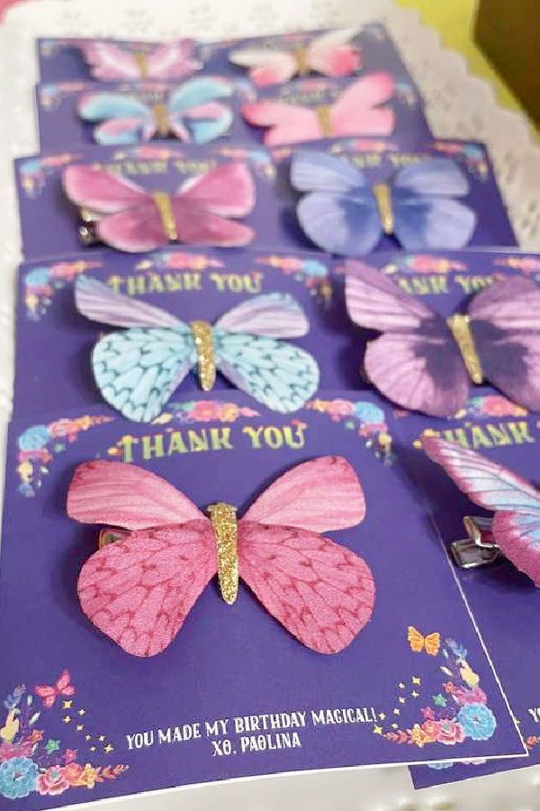 several butterflies are on top of a purple card