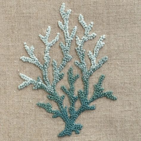 a close up of a piece of cloth with beads on it and a sea plant