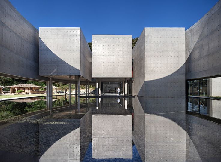 the exterior of a building with water reflecting on it