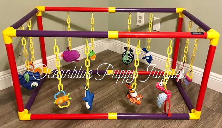 a play gym with toys hanging from it's sides