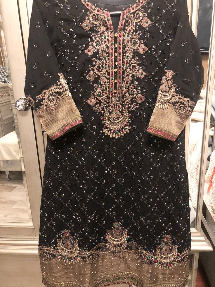 Very elegant black & metallic gold beautifully embroidery dress. Medium size Black Party Wear Dresses For Festivals, Black Party Wear Dress For Eid, Elegant Party Dresses With Resham Embroidery, Elegant Festive Embroidered Formal Dress, Elegant Embroidered Festive Dresses, Elegant Embroidered Dress For Eid Festival, Elegant Embroidered Dress For Eid, Elegant Gold Embroidered Dress For Party, Elegant Embroidered Dress For Party With Gold Details