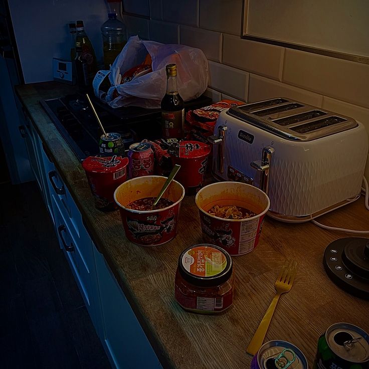 bowls of food are sitting on the counter next to toaster